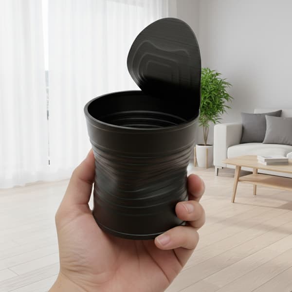 Sort urtepotte formet som en knust plantedåse, moderne design