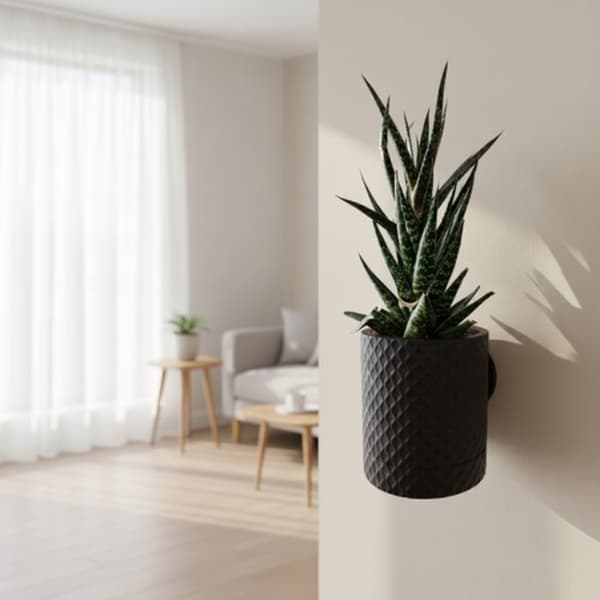 Svart blomkruka med diamantmönster och dold droppbricka
