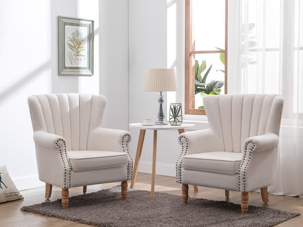 Vente-unique - BATOUMI krämfärgad tygfåtölj med nitar