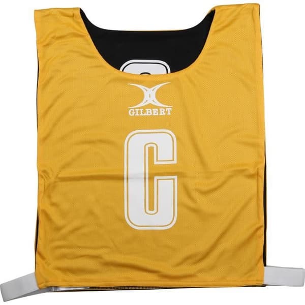 Reversibelt netball-dossard Gilbert - amber / svart - L