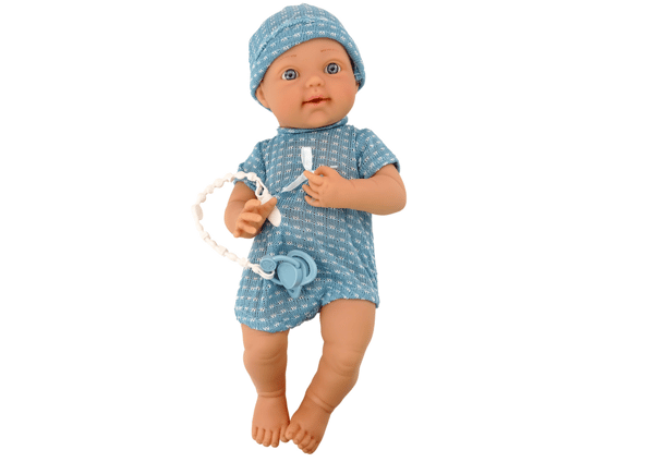 Babydocka i blå kläder, mössa, napp och filt
