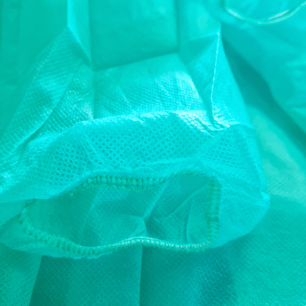 XXL grønt engangsforklæde med elastik (24g non-woven stof) 100 stk.