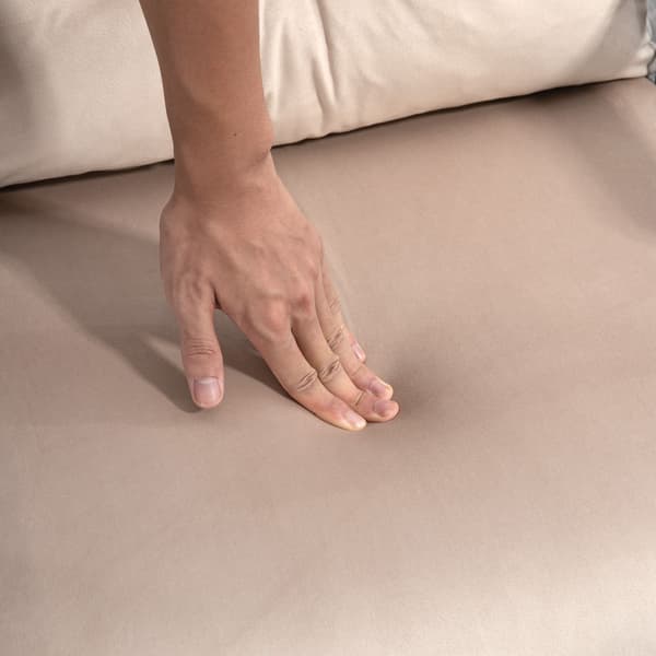 Beige bäddsoffa med sängfunktion och ryggkudde