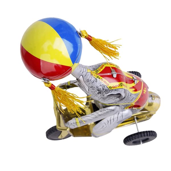 Wind-up clockwork elephant on a tricycle with a revolving ball, retro