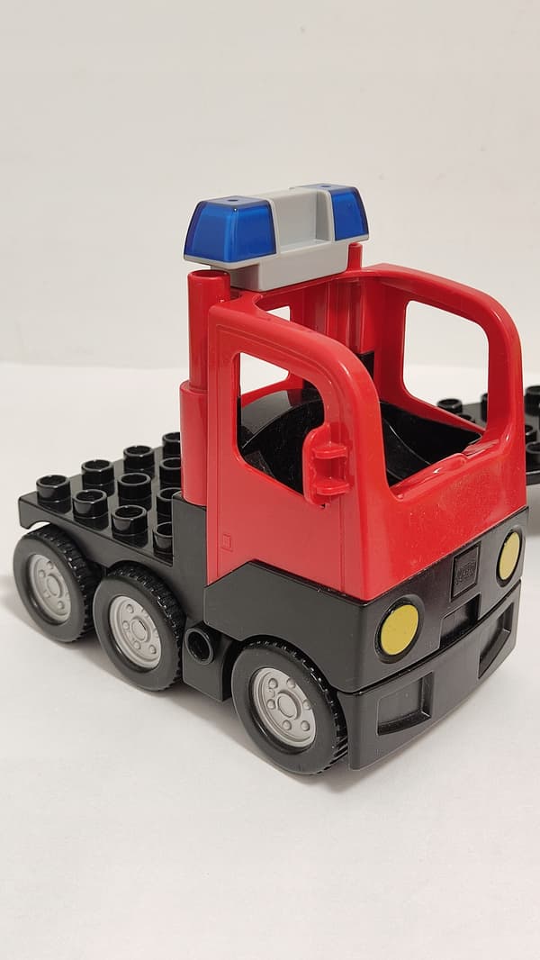 Lego Duplo building blocks: car, fire engine, trailer, ladder, dinghy