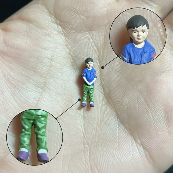 1/64 scale figurine of a boy. Micro-scale boy figurine for display on a tabletop