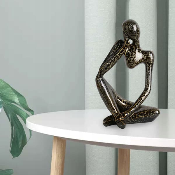 Modern abstract statue of a thinker, black, left-facing L