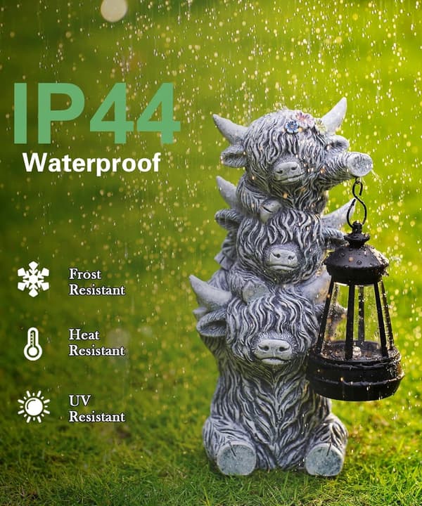 Scottish cow figurine with a solar-powered lantern