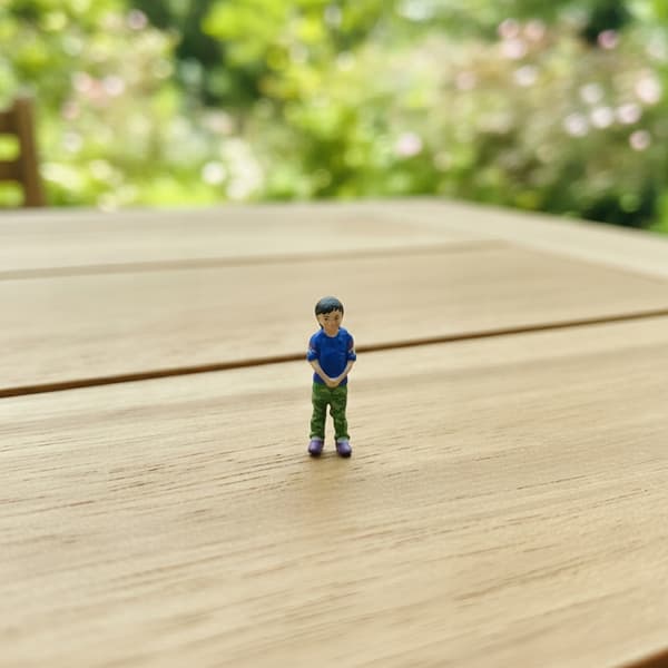 1/64 scale figurine of a boy. Micro-scale boy figurine for display on a tabletop