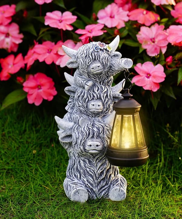 Scottish cow figurine with a solar-powered lantern