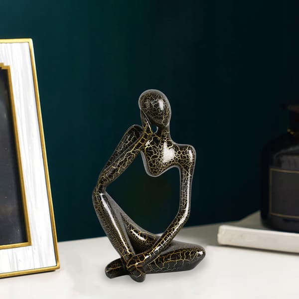 Modern abstract statue of a thinker, black, left-facing L