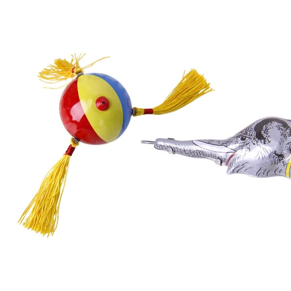 Wind-up clockwork elephant on a tricycle with a revolving ball, retro