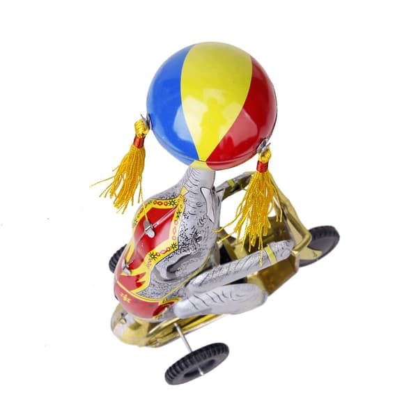 Wind-up clockwork elephant on a tricycle with a revolving ball, retro