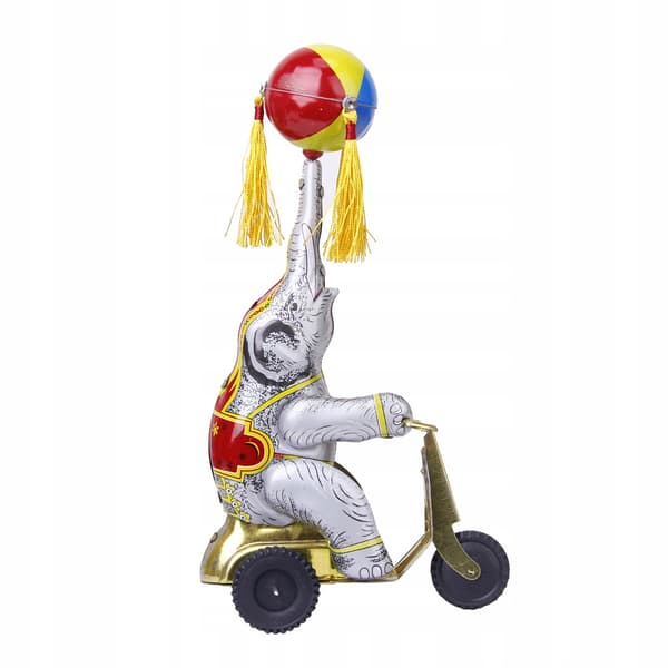 Wind-up clockwork elephant on a tricycle with a revolving ball, retro
