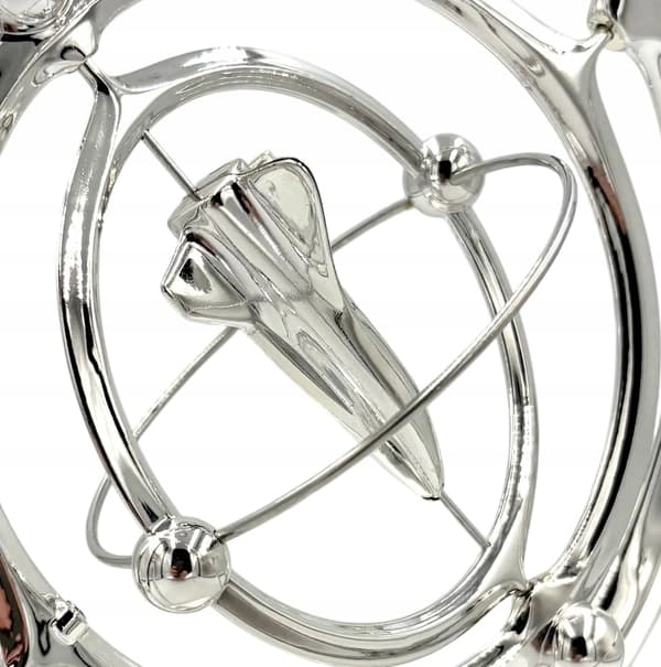 Battery-powered perpetual motion machine with a rocket – decorative silver rocket, space-themed ornament