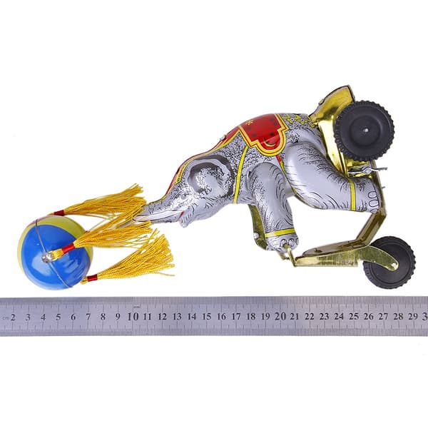 Wind-up clockwork elephant on a tricycle with a revolving ball, retro