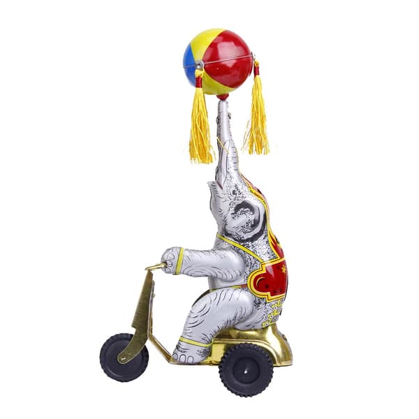 Wind-up clockwork elephant on a tricycle with a revolving ball, retro