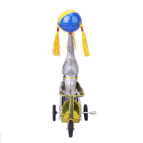 Wind-up clockwork elephant on a tricycle with a revolving ball, retro