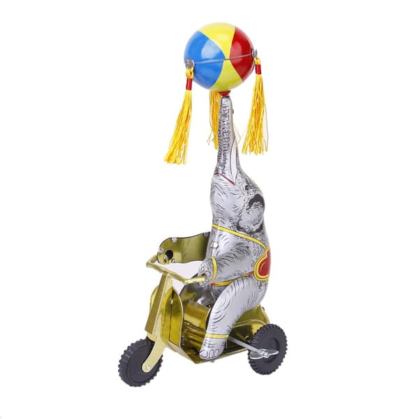Wind-up clockwork elephant on a tricycle with a revolving ball, retro