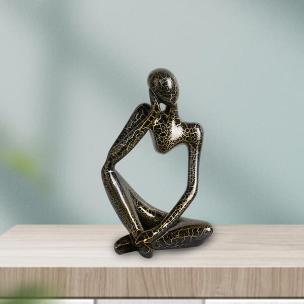 Modern abstract statue of a thinker, black, left-facing L