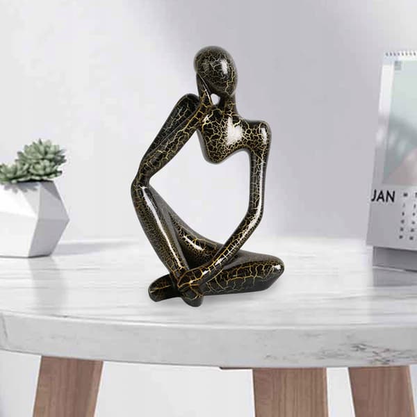 Modern abstract statue of a thinker, black, left-facing L