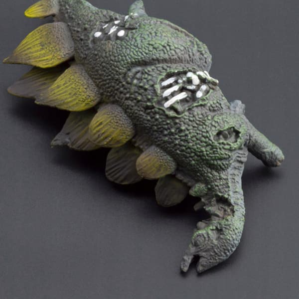 Dinosaur Skeleton Model: A realistic, weathered model of a Stegosaurus skeleton