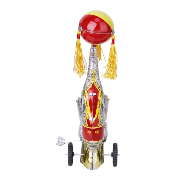 Wind-up clockwork elephant on a tricycle with a revolving ball, retro
